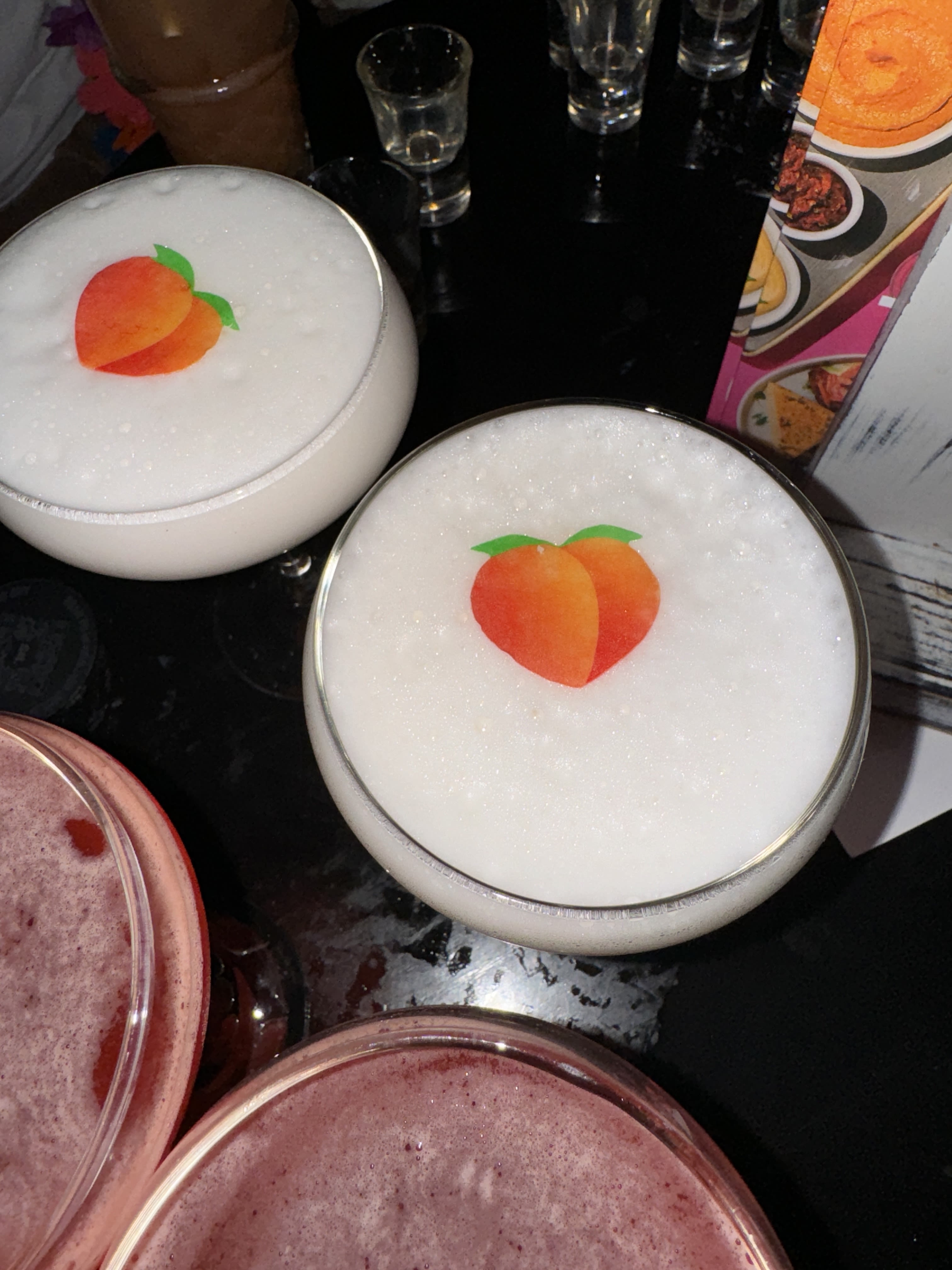 man in red polo shirt pouring wine on clear wine glass