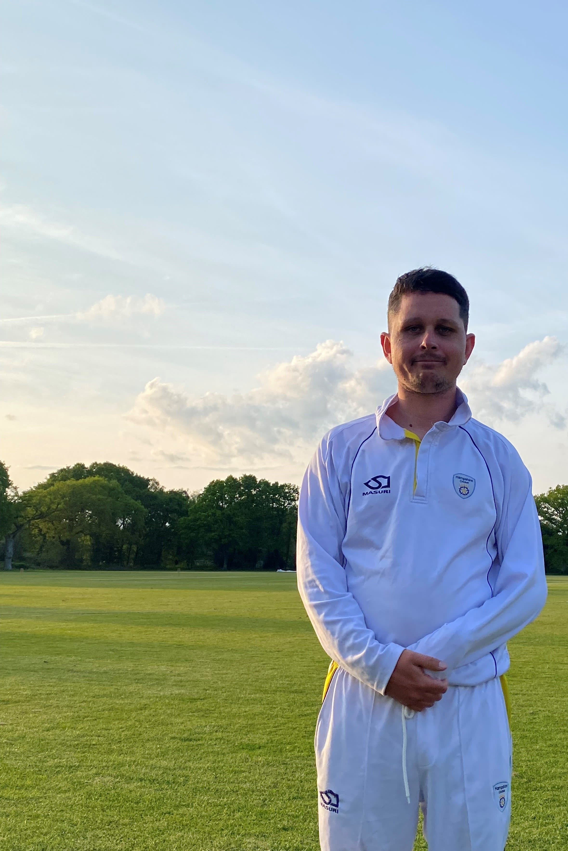 Ashley Humber smiling for the camera in a portrait shot, wearing Bournemouth Cricket Club kit