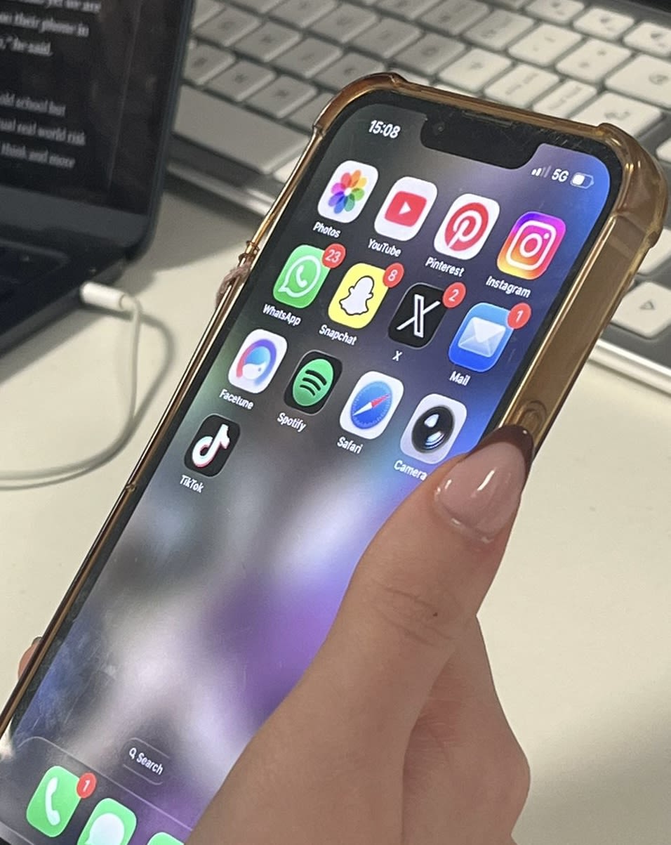 white smartphone near laptop