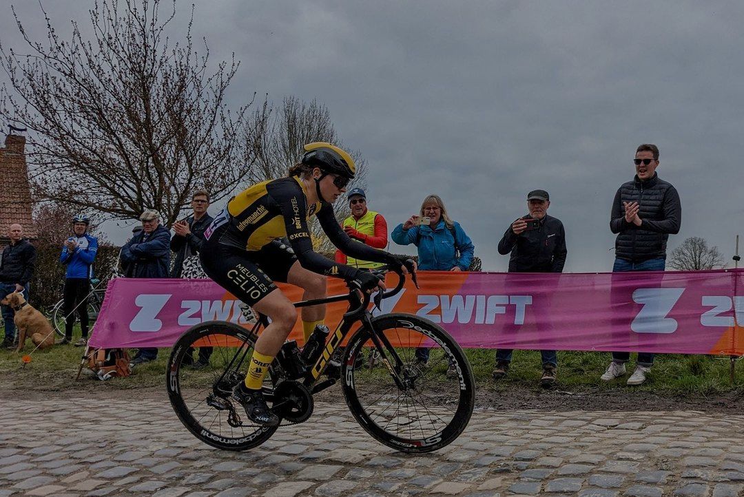 Lucy Gadd racing across the Paris-Roubaix cobblestones, her family cheering on in the background