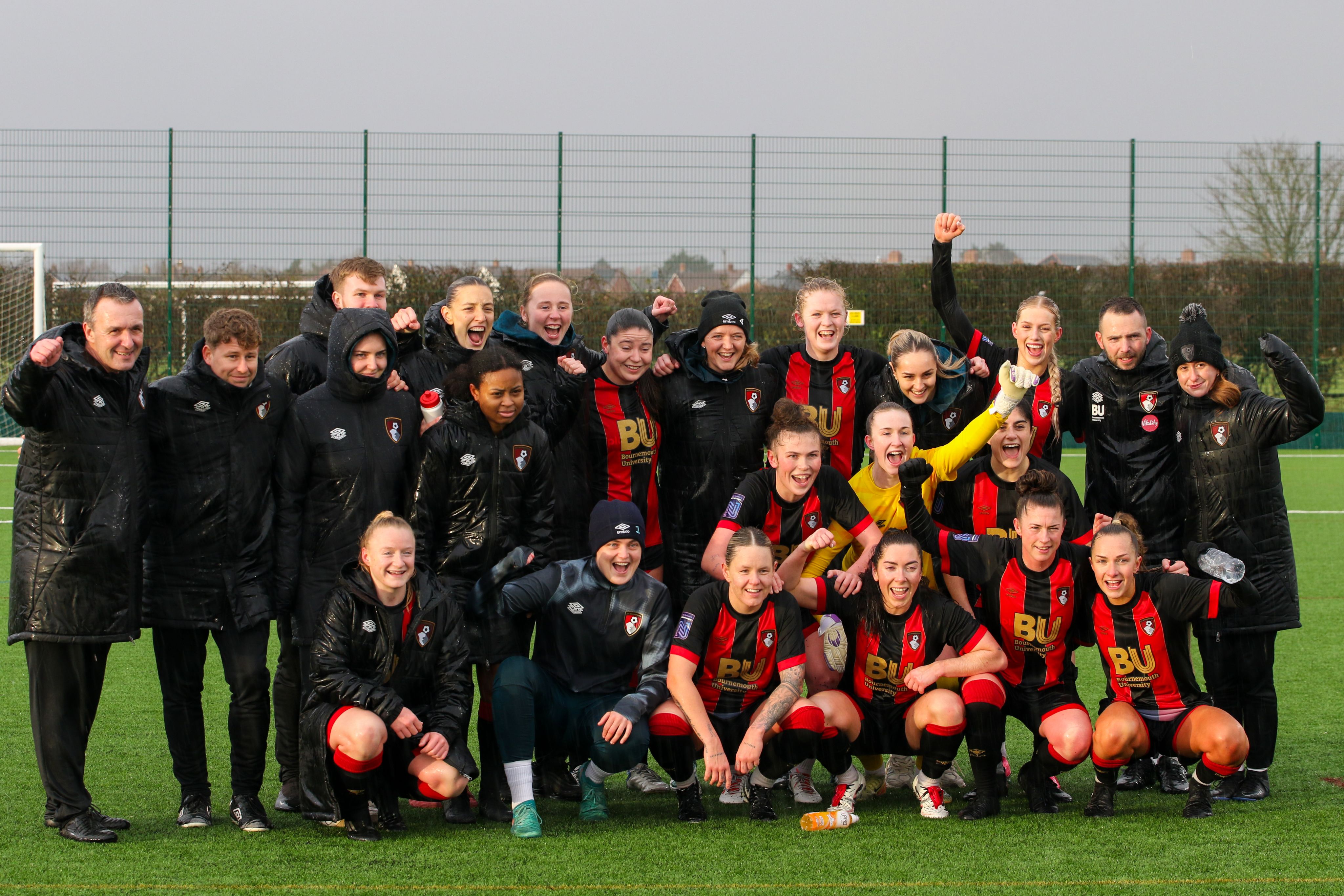 Steve Cuss and his AFC Bournemouth Women's side pose for a photo after their semi-final cup win against Manchester United u21s.