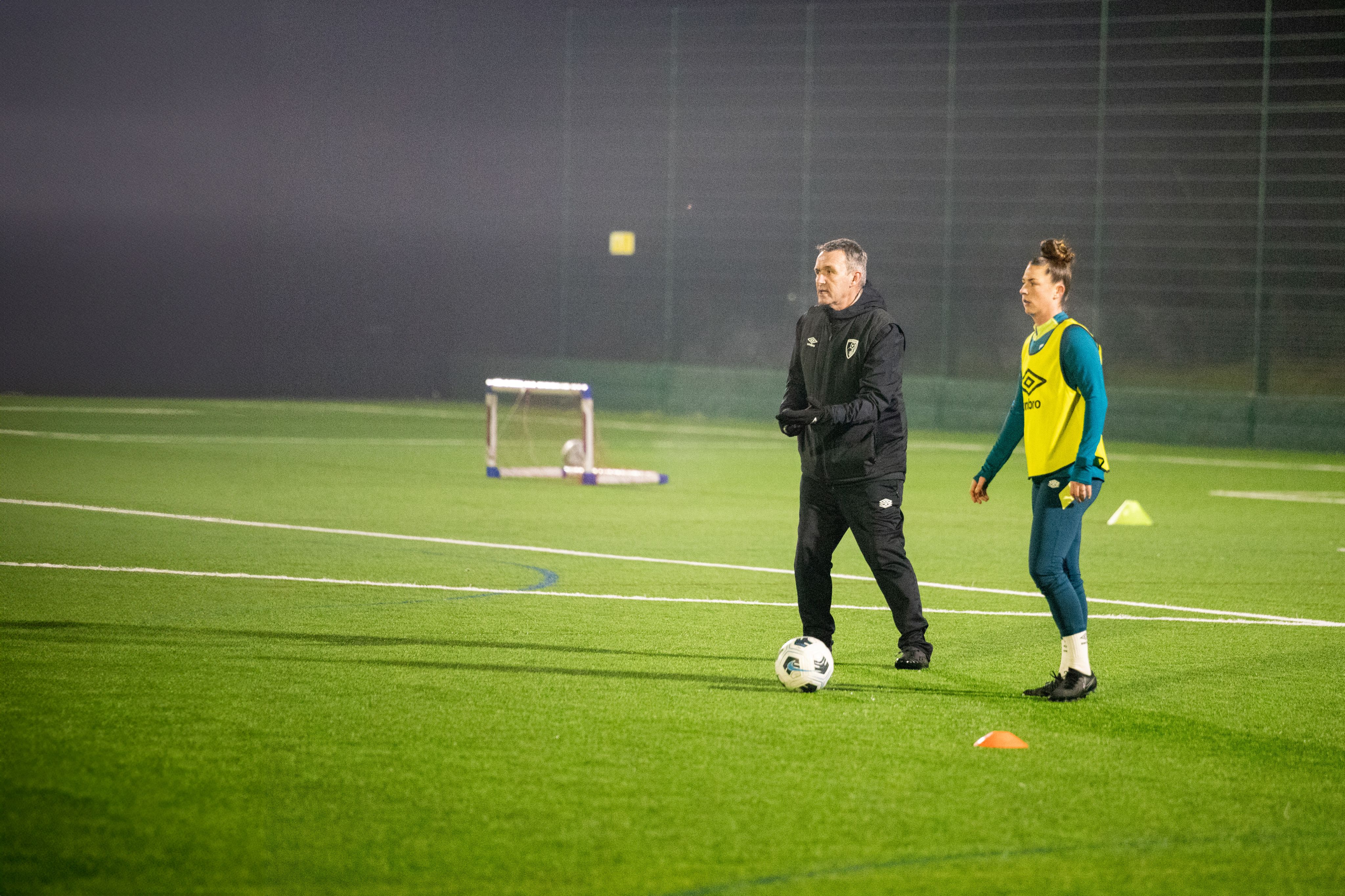 Steve Cuss giving his team instructions stood next to Molly Barron-Clark at training
