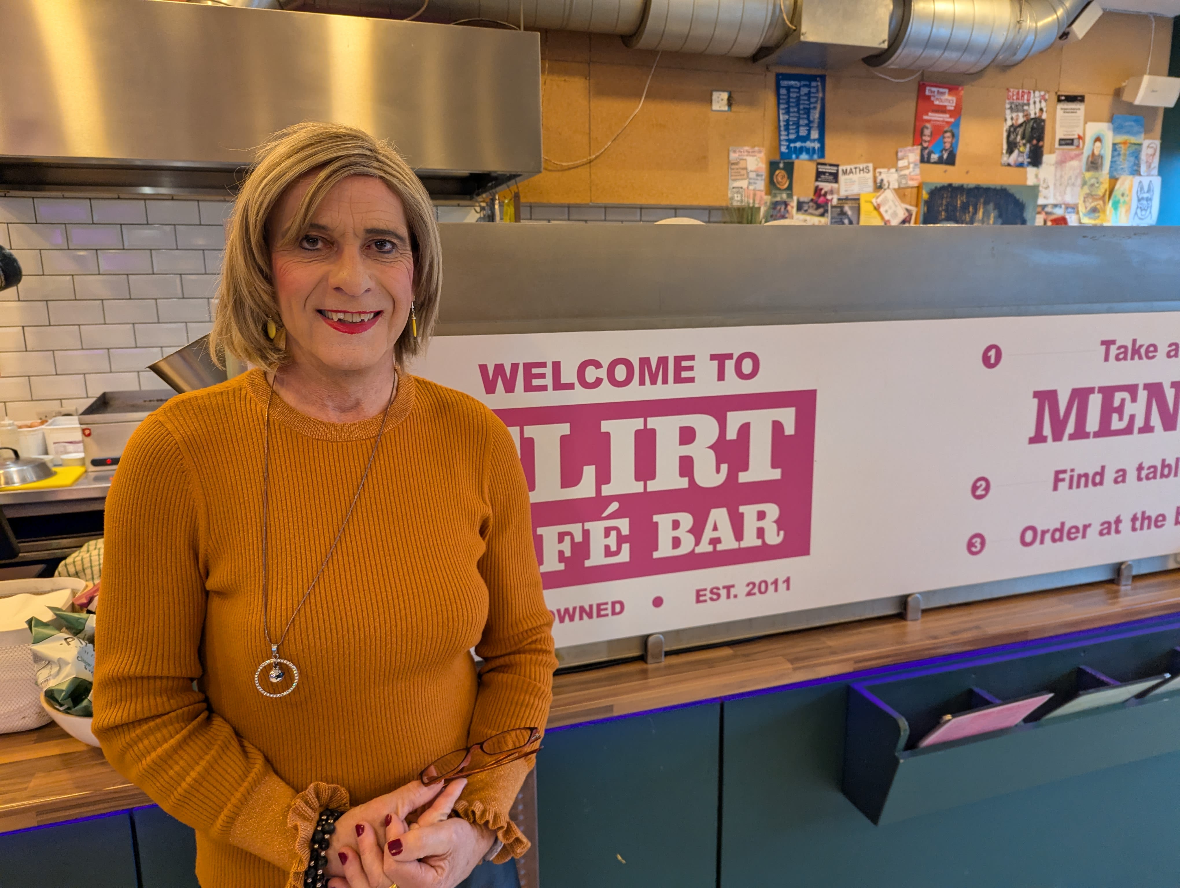 A gender specialist smiling in an LGBT cafe
