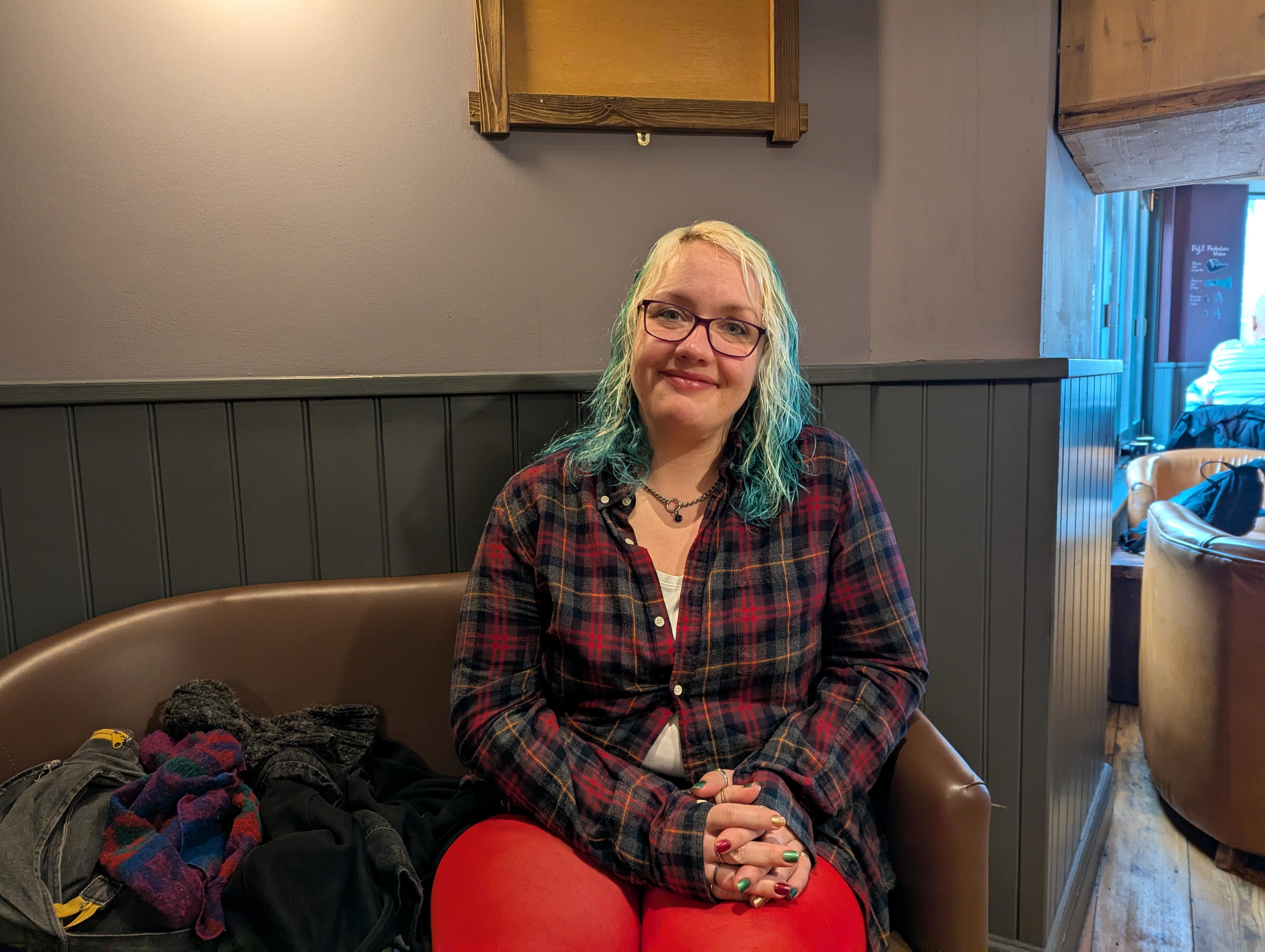 Laura, an interviewee, smiling in a coffee shop